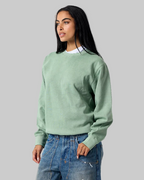 Model wearing Smart Blanks 8003 heavyweight crewneck sweatshirt in Vintage Sage, 12 oz 400 GSM blank
