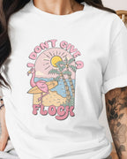 Person wearing a white t-shirt with a colorful graphic design and text.