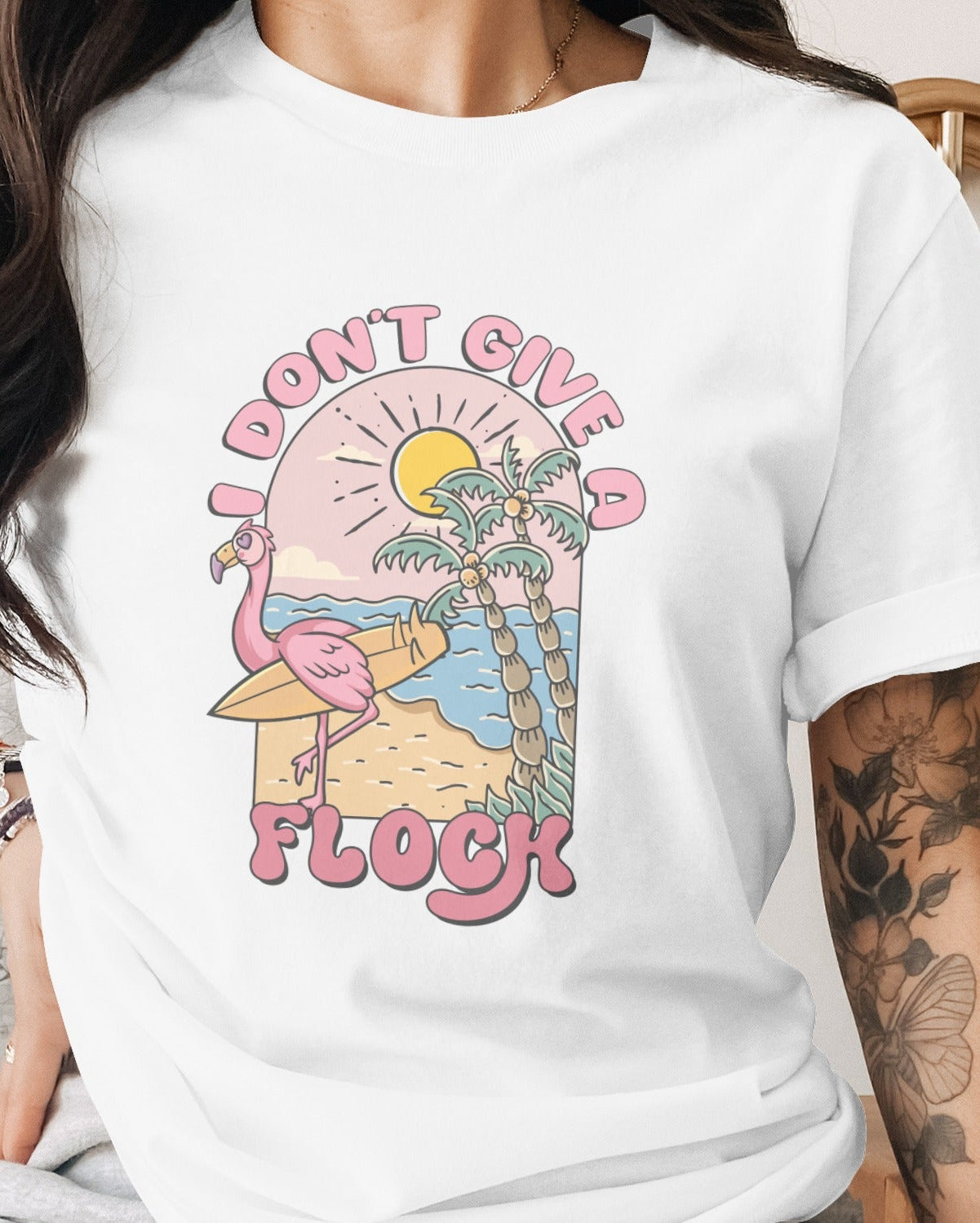 Person wearing a white t-shirt with a colorful graphic design and text.