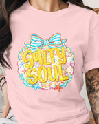 Person wearing a pink t-shirt with 'Salty Soul' design