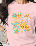 Person wearing a pink t-shirt with colorful bow design