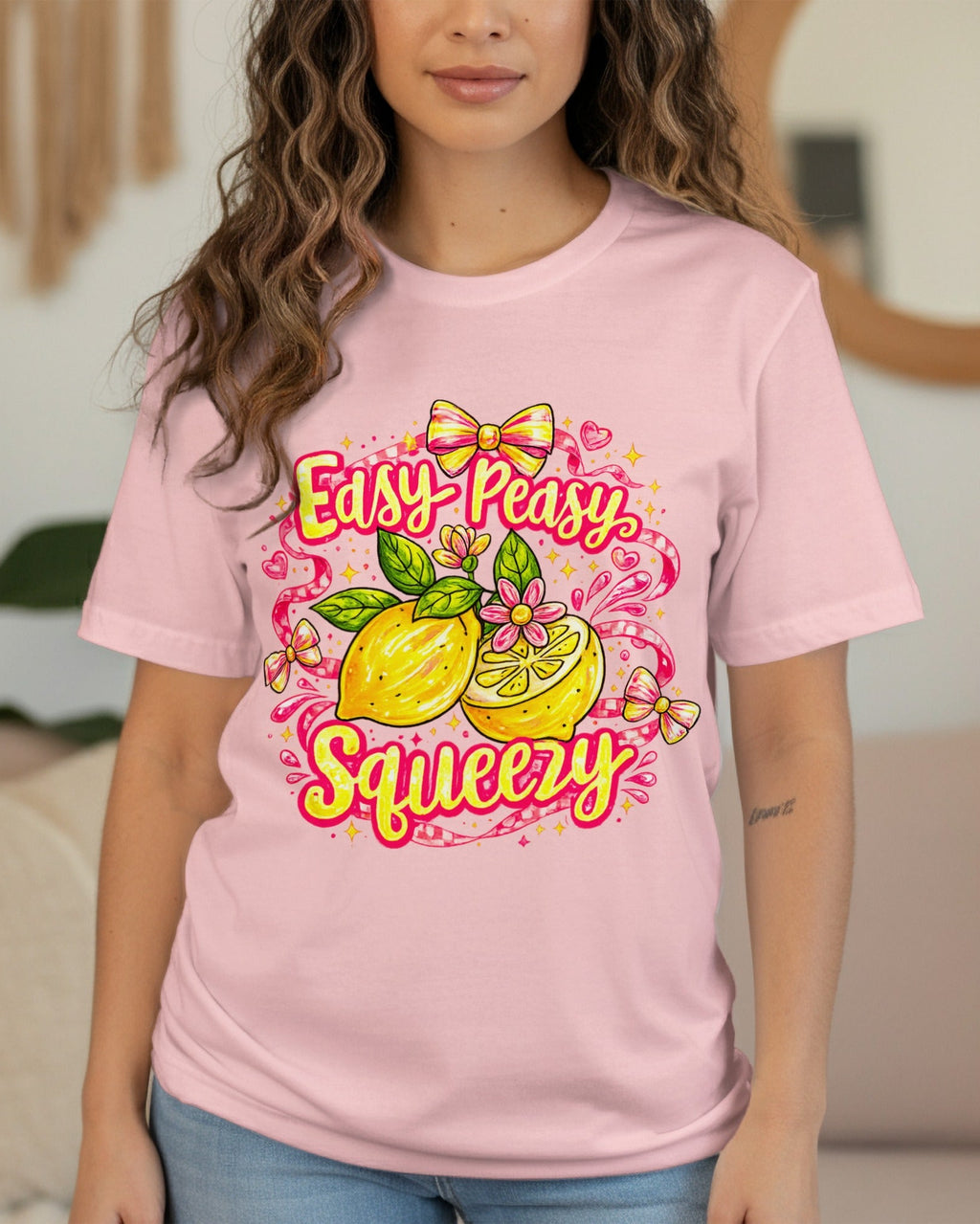 Person wearing a pink t-shirt with a lemon graphic and text in a living room.