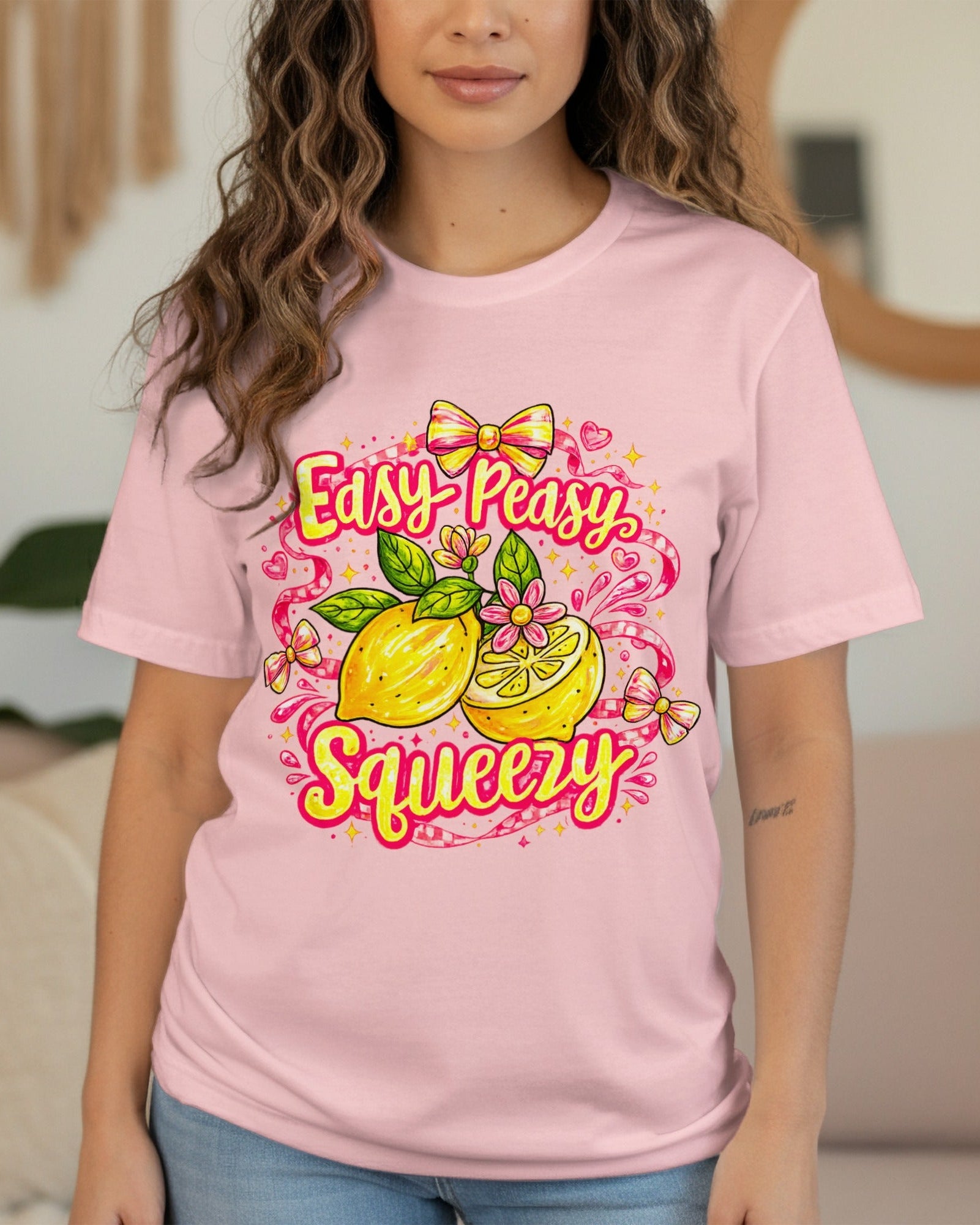 Person wearing a pink t-shirt with a lemon graphic and text in a living room.