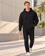 S&S Textiles 157A blank pullover hoodie in Black, on model outdoors, 8.3 oz 280 GSM blank