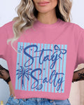 Person wearing a pink t-shirt with 'Stay Salty' design, standing against a neutral background.