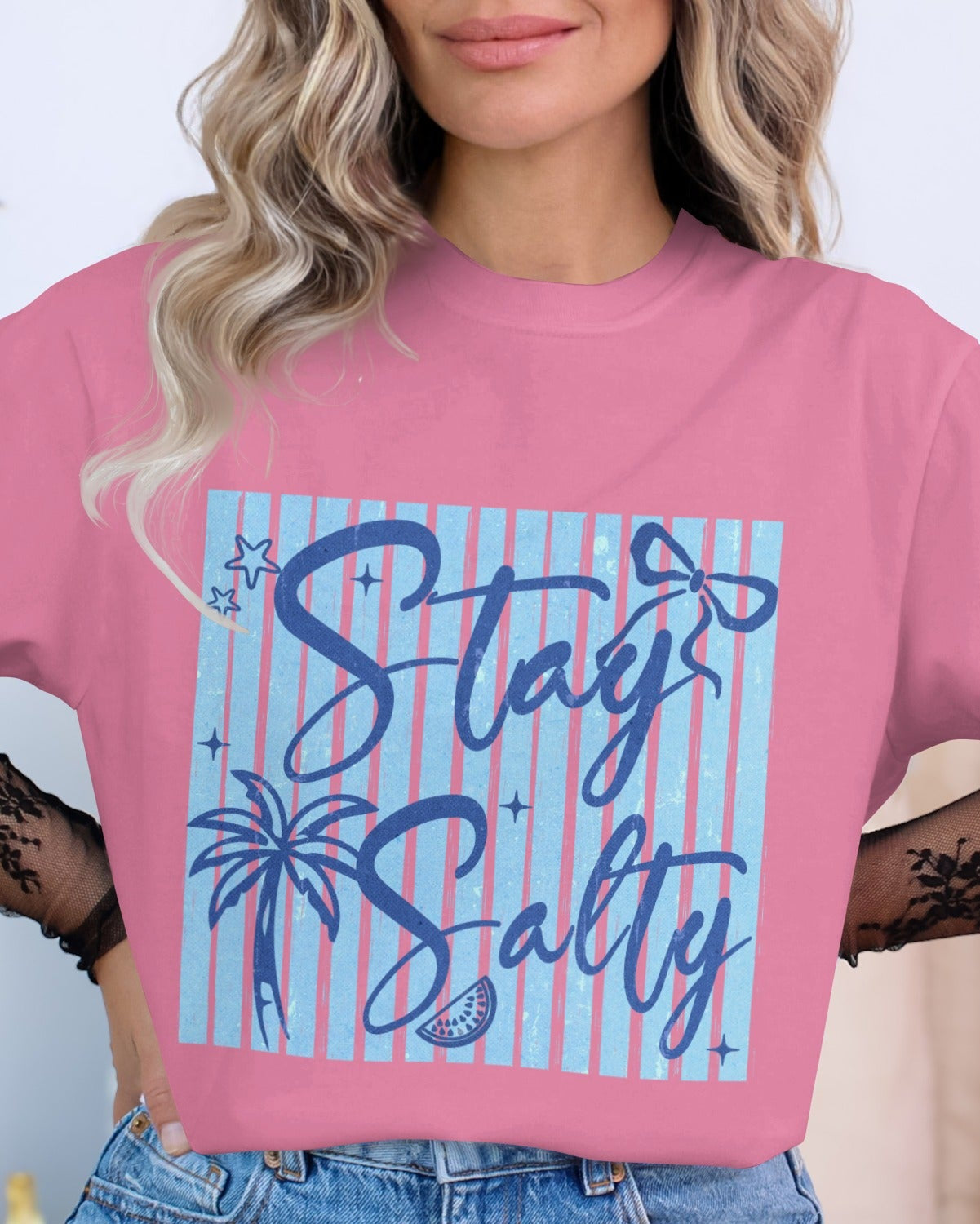 Person wearing a pink t-shirt with 'Stay Salty' design, standing against a neutral background.