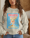 Woman wearing a sweatshirt with a margarita graphic and text.