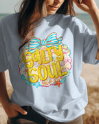 Person wearing a t-shirt with 'Salty Soul' design on a beach