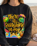 Black sweatshirt with tropical design and text 'there is sunshine in my soul' on a beach.